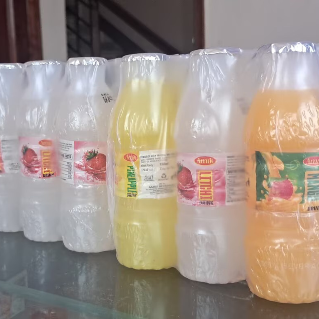 Bottles of Amrit Beverages on a wooden table
